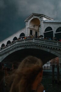 a crowd of people standing on top of a bridge